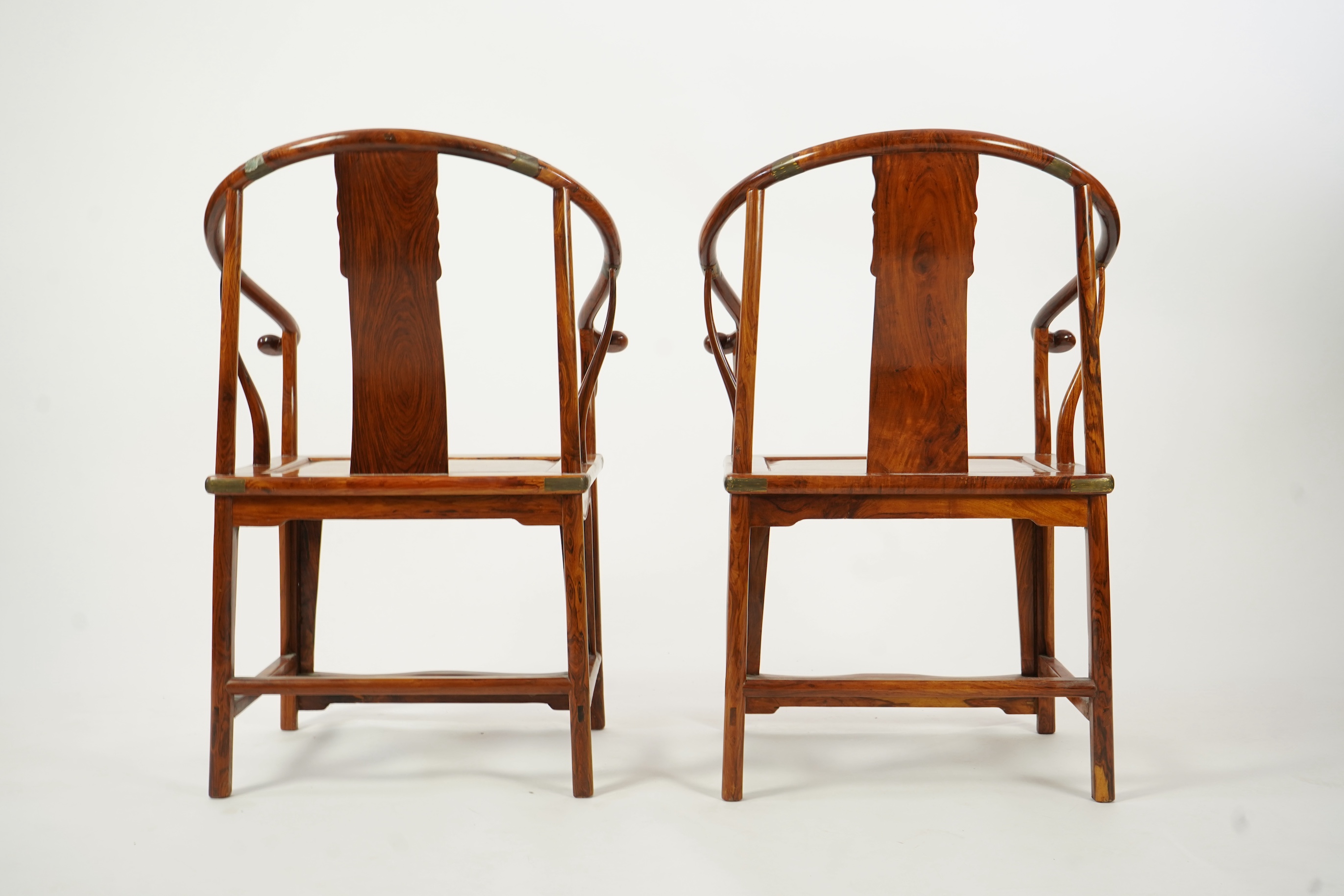 A pair of Chinese huanghuali and brass mounted horseshoe-back armchairs, quanyi, 19th century